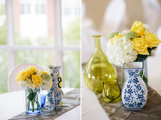 Yellow and white wedding centerpiece with blue vases