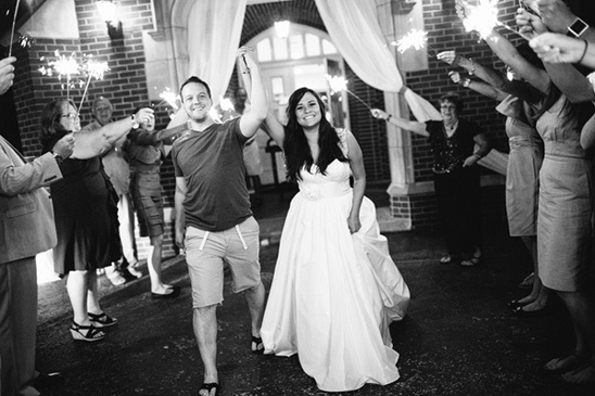 Couple exits wedding venue sparklers