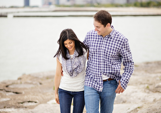 Happy couple strolling along a lake shore