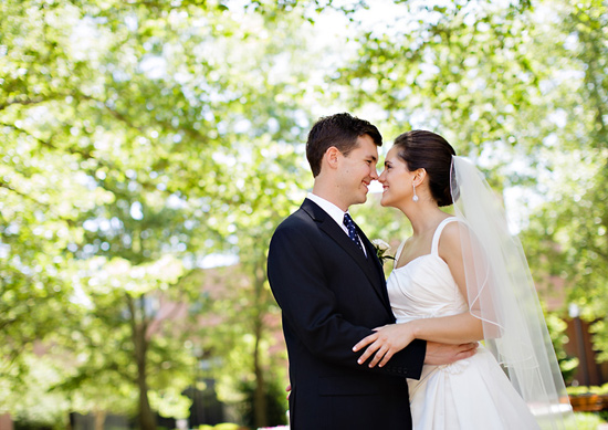 Bride and groom embrace on their wedding day outdoors