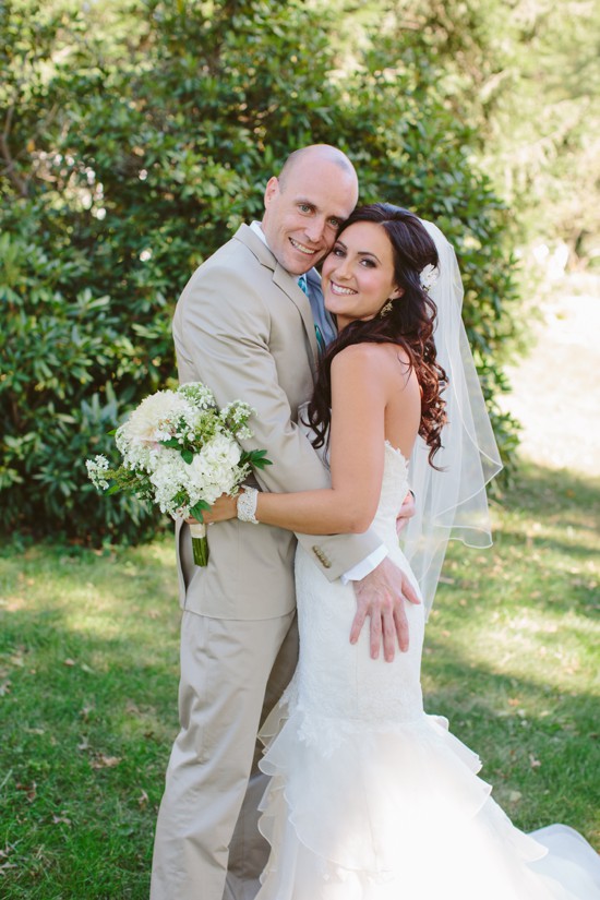 Happy bride and groom hug on their wedding day outdoors