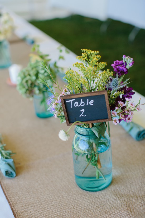 Table number with flowers in a mason jar centerpiece