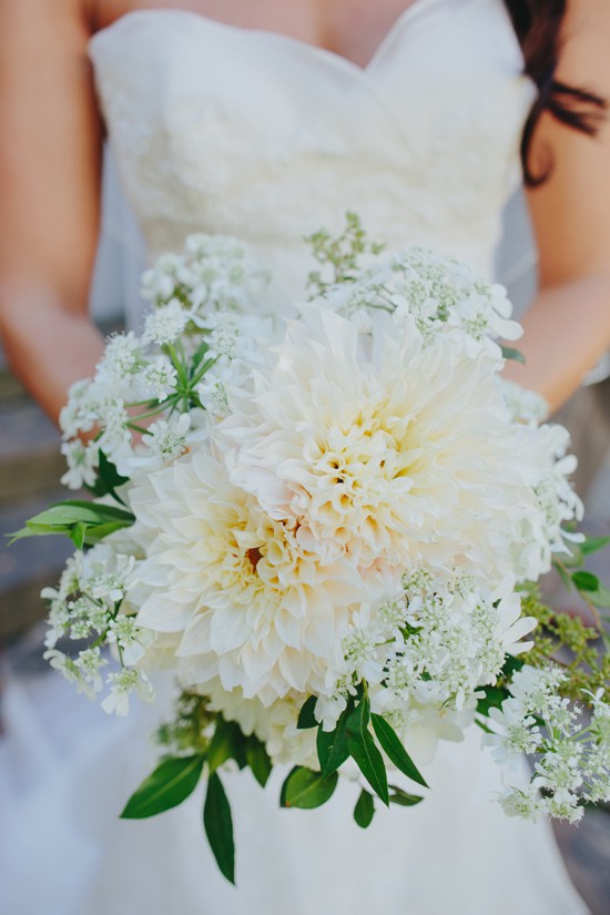 Bride holds beautiful white dahlia wedding bouquet