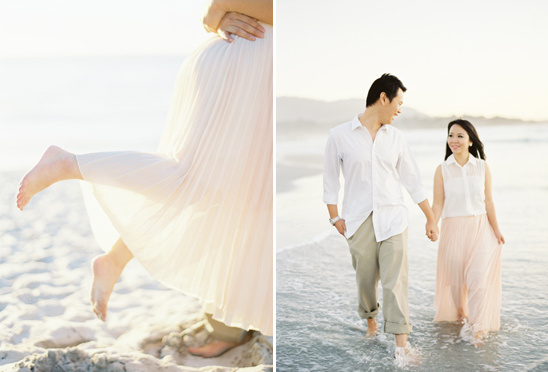 Couple walks beach in light outfits