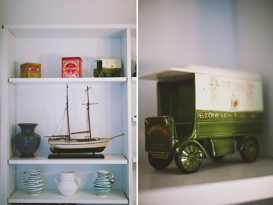 Shelves with vintage toy truck sailboat and antique vases