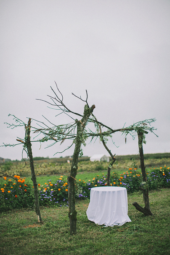 Rustic wedding altar with flower field backdrop
