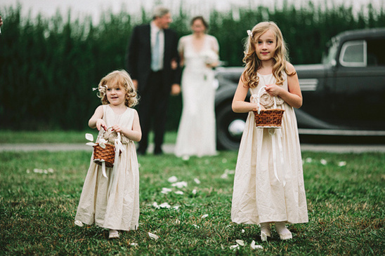 Flower girls at a charming outdoor wedding ceremony