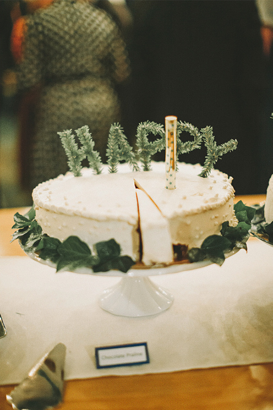 Happy birthday cake decorated with greenery