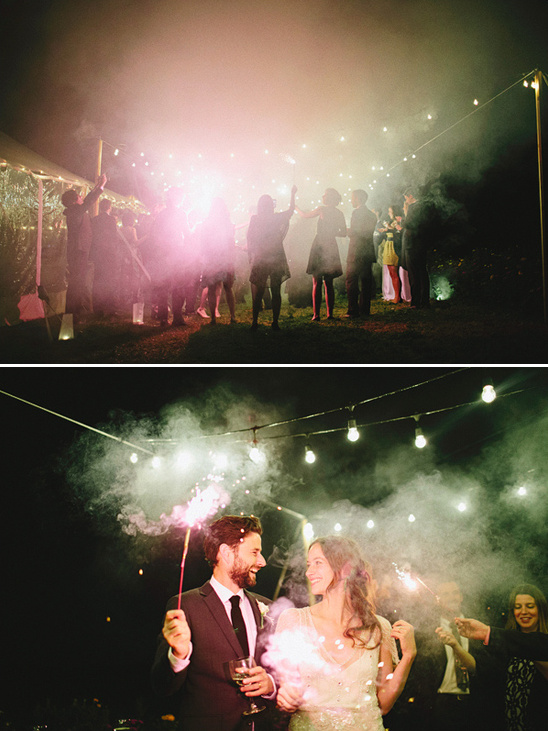Wedding guests celebrate with sparklers at night