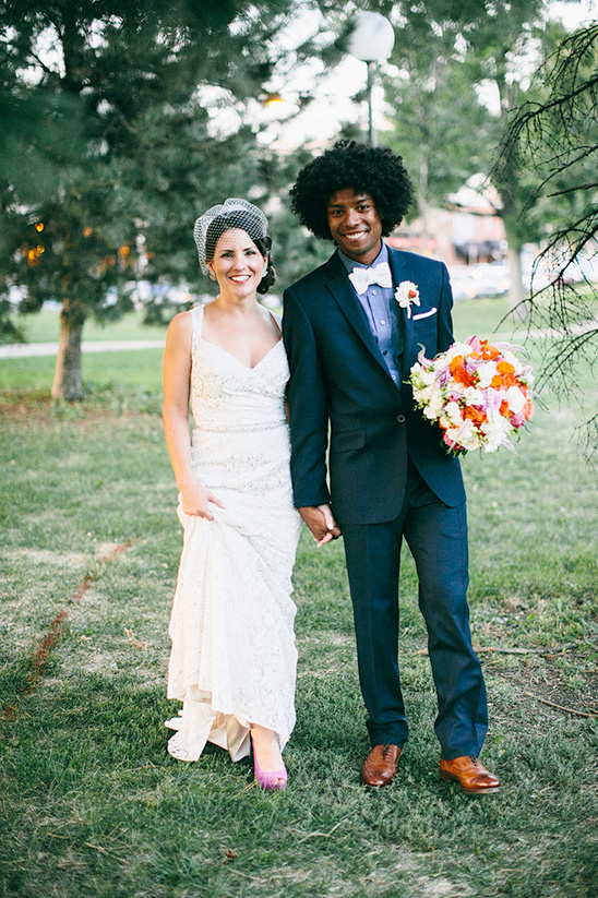 Happy newlywed couple holding hands, smiling