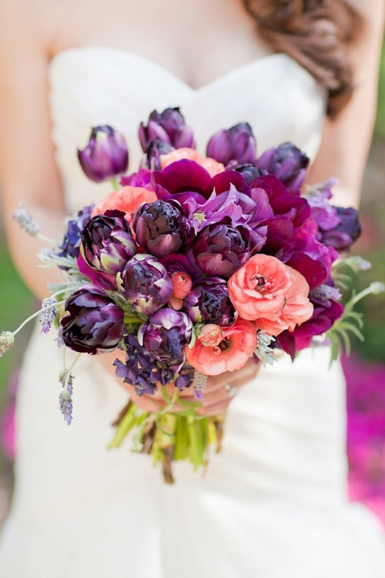 Bride holding a purple and peach wedding bouquet