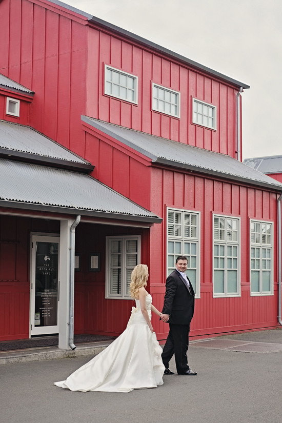Couple in wedding attire red building