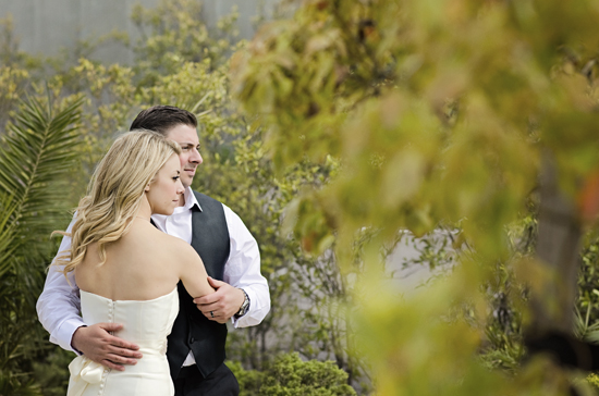 Bride and groom embrace outdoors on their wedding day