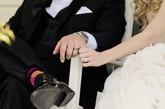 Couple holding hands wedding rings