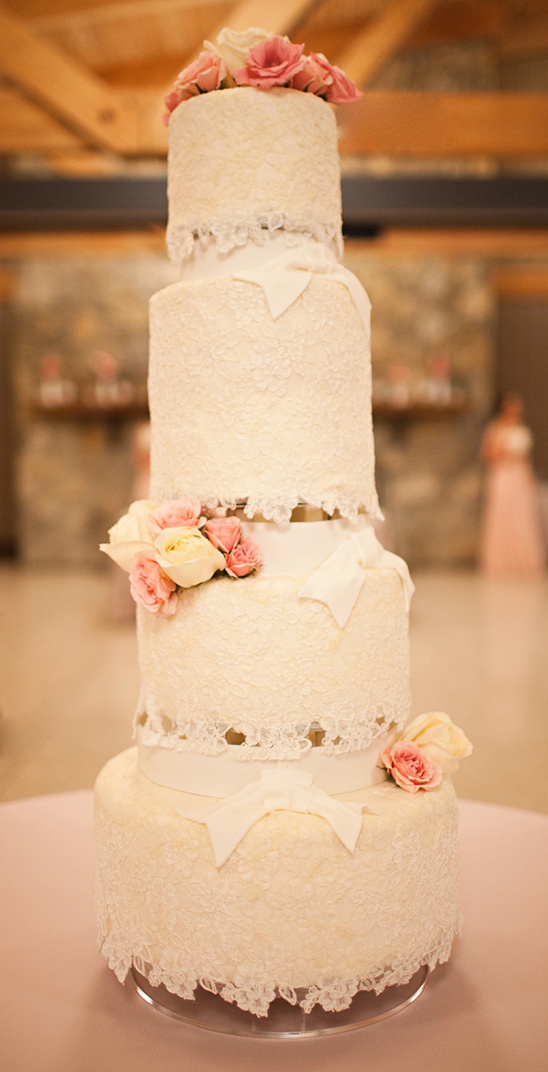 Elegant four-tiered wedding cake with lace
