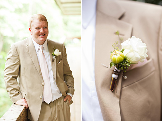 Groom in tan suit with pink tie and boutonniere