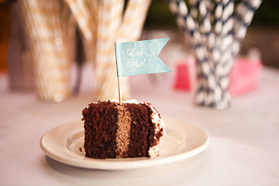 Delicious chocolate cake slice with Eat Me flag