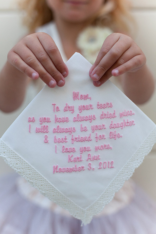 A young girl presents a personalized handkerchief with loving words