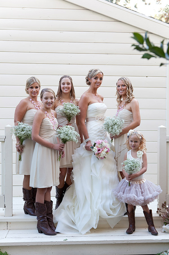Bride and bridesmaids posing for a photo in a wedding attire