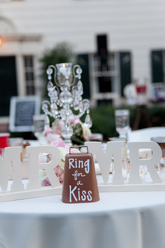 Wedding reception with Ring for a Kiss bell on a table