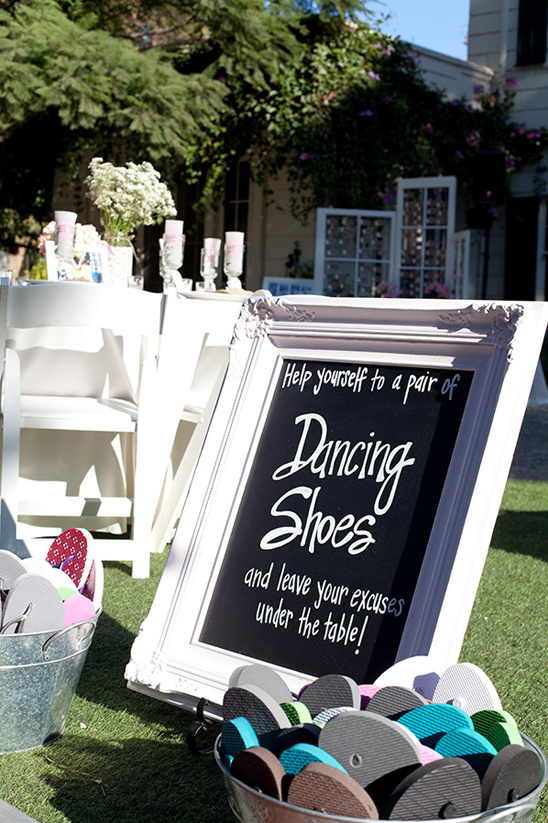 Dancing shoes sign with flip-flops for guest comfort at event
