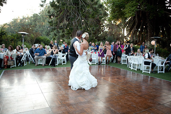 Bride and groom share their first dance at a garden wedding reception