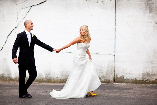 Bride and groom walking holding hands outdoors