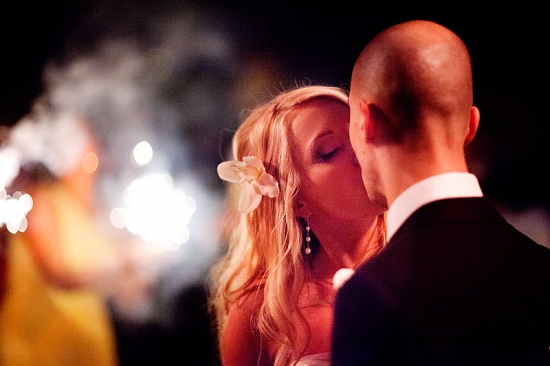 Newlyweds share a kiss at their wedding reception