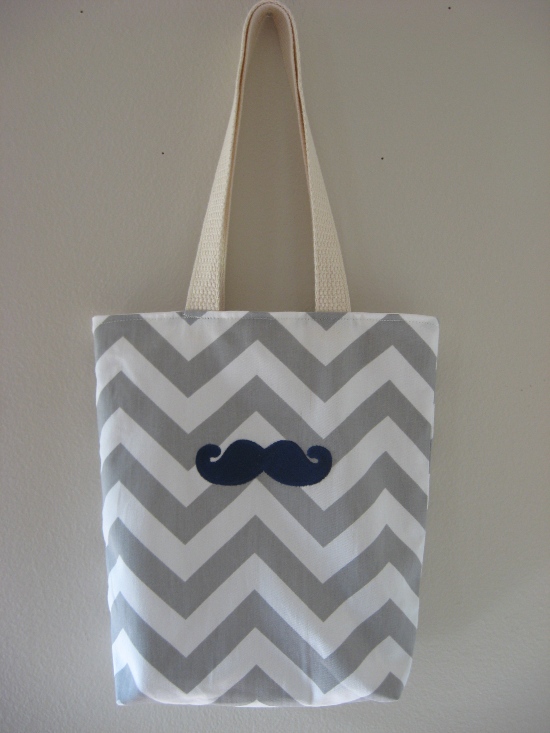 Gray chevron tote bag with a mustache design