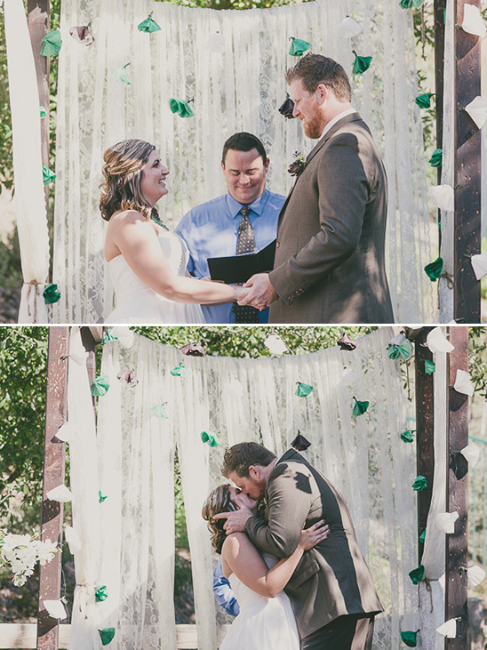 Bride and groom at outdoor wedding ceremony kissing