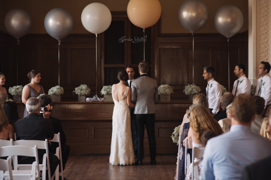 Indoor wedding ceremony with bride groom and guests