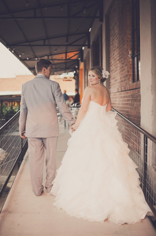 Bride and groom walking away holding hands