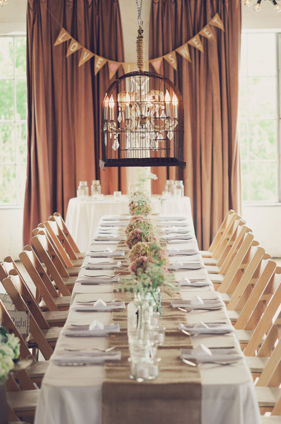 Rustic wedding table setting with birdcage chandelier