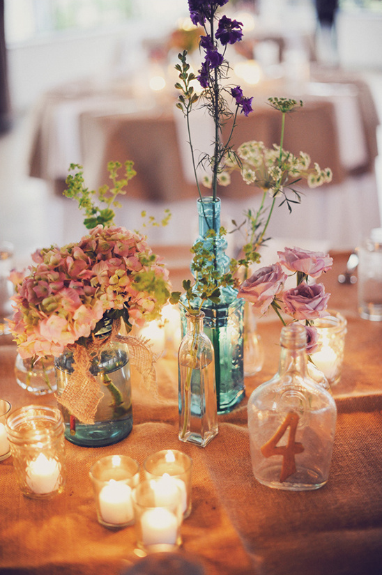 Rustic wedding table centerpiece with wildflowers and candles