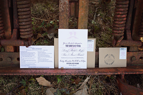 Rustic wedding invitations on vintage farm equipment
