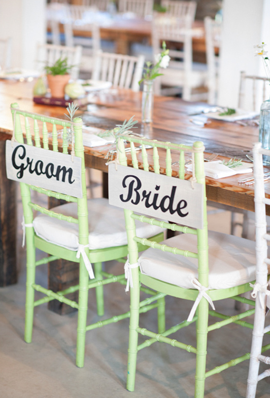 Green chairs with Groom and Bride signs
