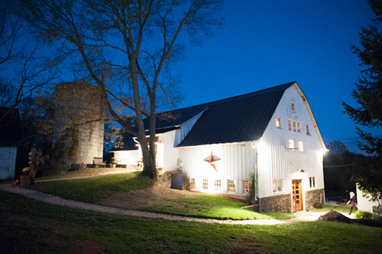 White barn at night, rural setting