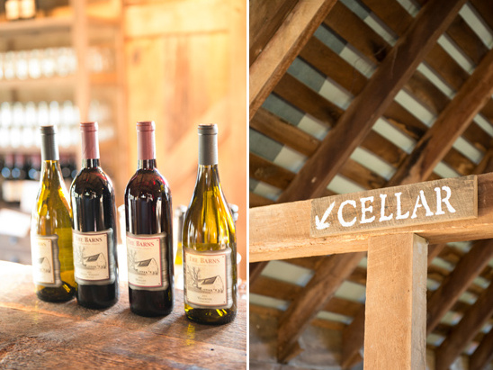 Wine bottles on wooden counter; cellar sign