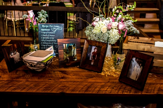 Rustic wedding table with framed photos and recipe for love