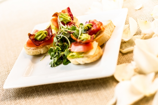 Delicious appetizer with bacon, tomato and avocado, ready to be served