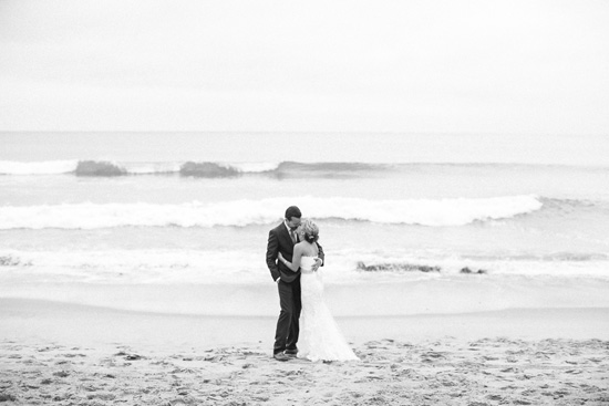 Beach wedding photo of bride and groom kissing