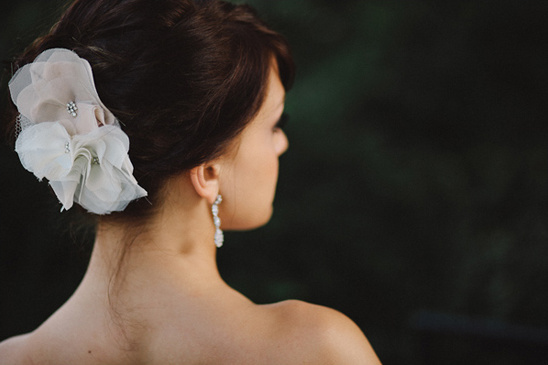 Bride with elegant flower hair accessory and earrings