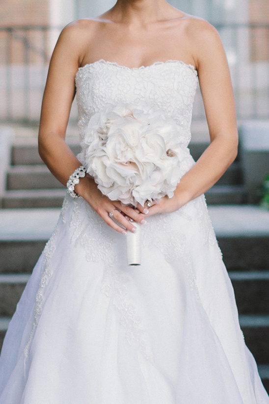 Bride in white lace gown holding a bouquet