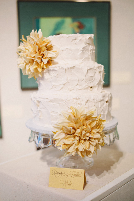 White cake with raspberry filling and flower decorations