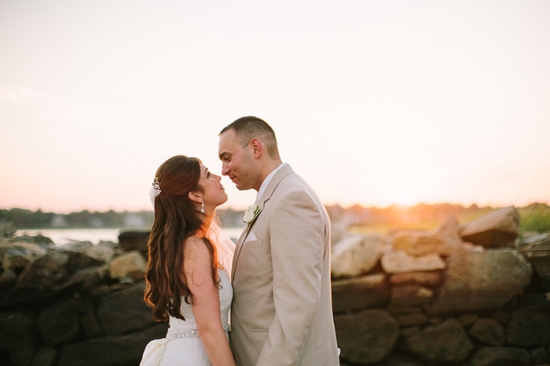 Bride and groom share a loving gaze at sunset