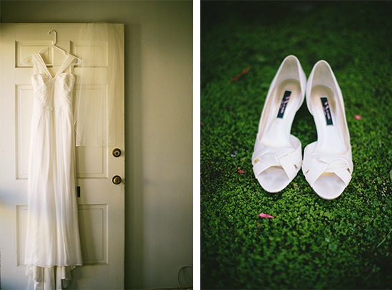 Elegant wedding dress hanging with white shoes on grass