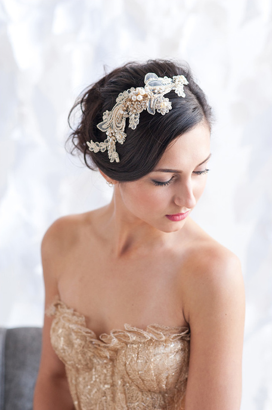 Bride wearing beaded lace headpiece and gold corset