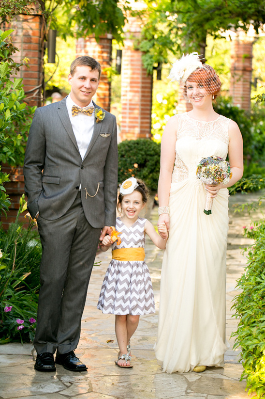 Happy family wedding photo: bride, groom, flower girl