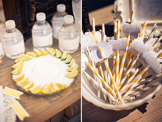 Water bottles, lime salt, and yellow striped straws for a party