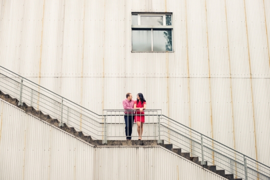 Couple in love on metal stairs, urban background
